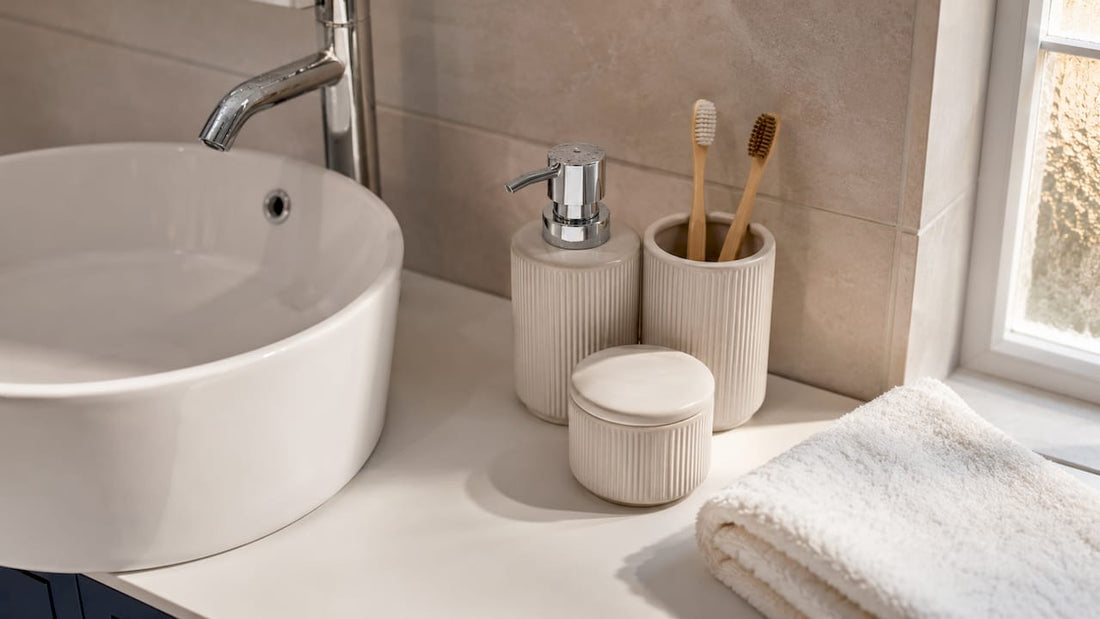 Ceramic bathroom accessories on marble countertop