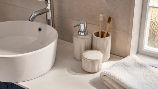 Ceramic bathroom accessories on marble countertop
