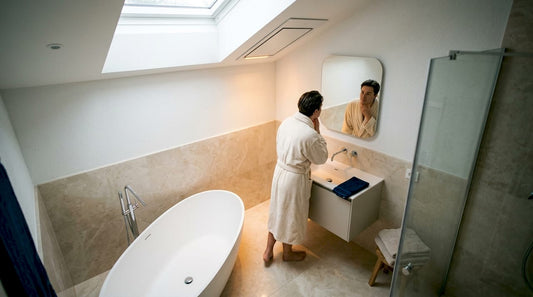 Person in bathroom under infrared heater panel