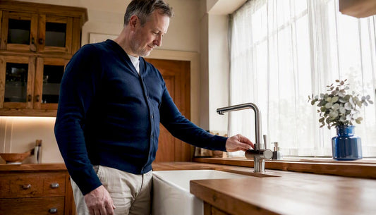 Homeowner inspecting boiling water tap in kitchen