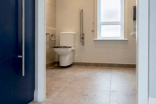 Interior of UK ambulant toilet showing fittings and space