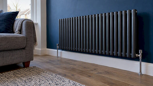 Designer radiator mounted on a navy living room wall